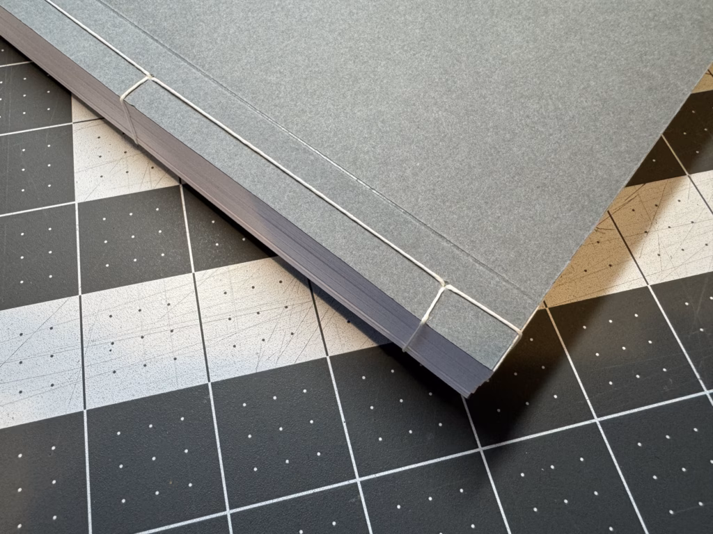 A detailed image of a booklet bound with Japanese stab binding